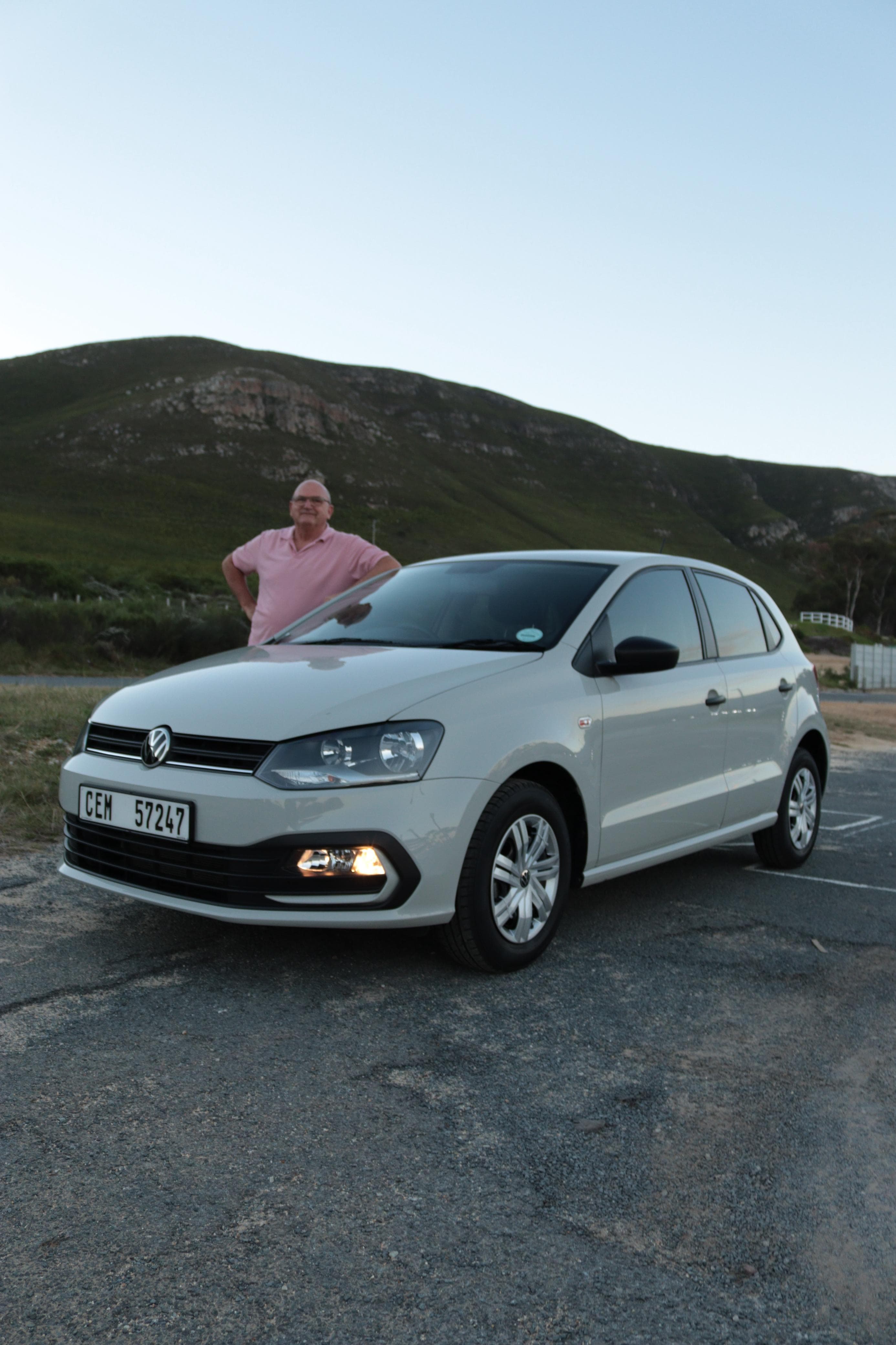 The white VW Polo Vivo and your instructor at dusk, Hermanus mountains behind